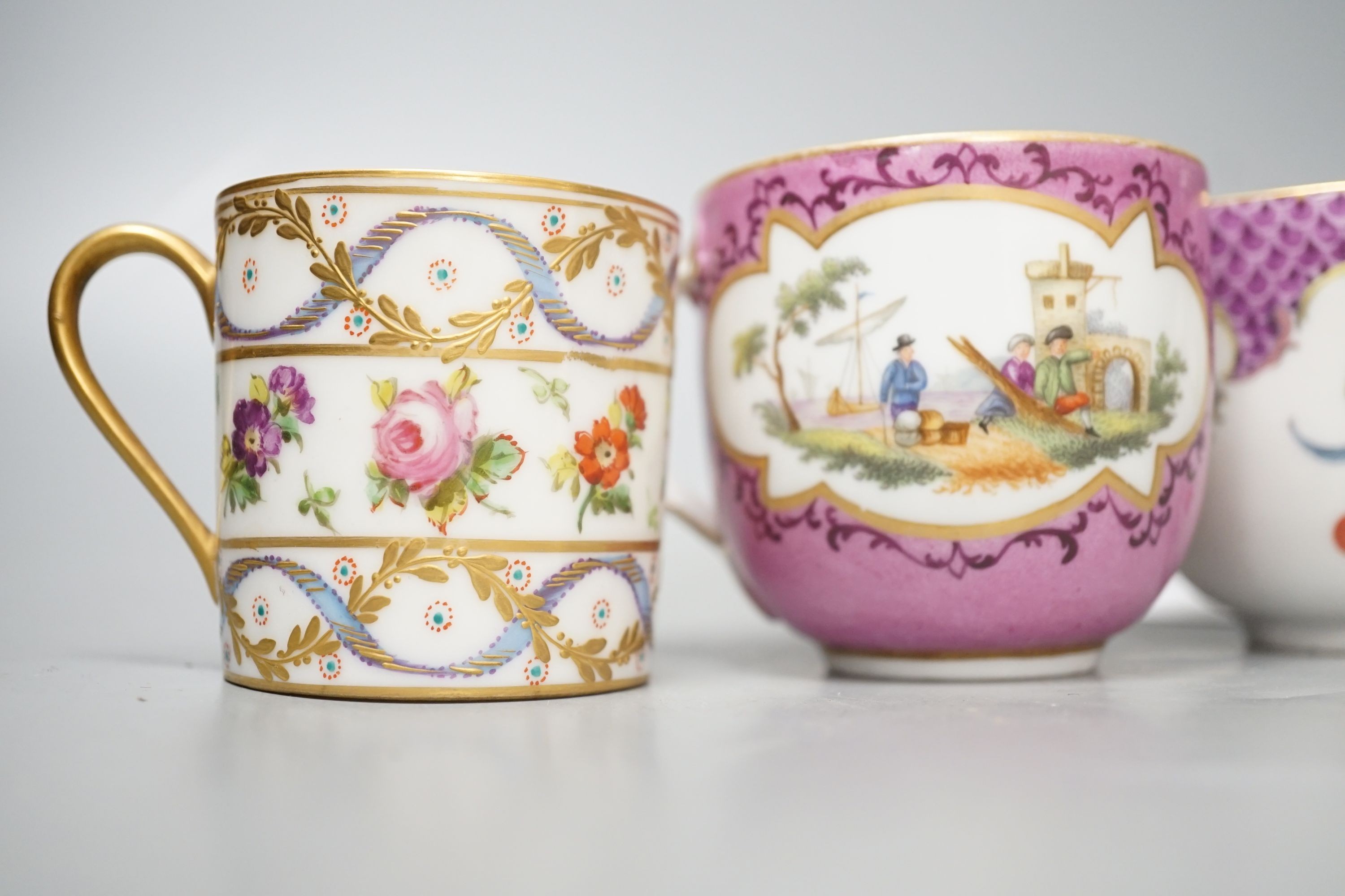 An 18th century Meissen pink ground coffee cup with entwined handle painted on two sides with a figural landscape on a pink ground, a 19th century French box and cover painted with flowers, a German coffee cup with pink